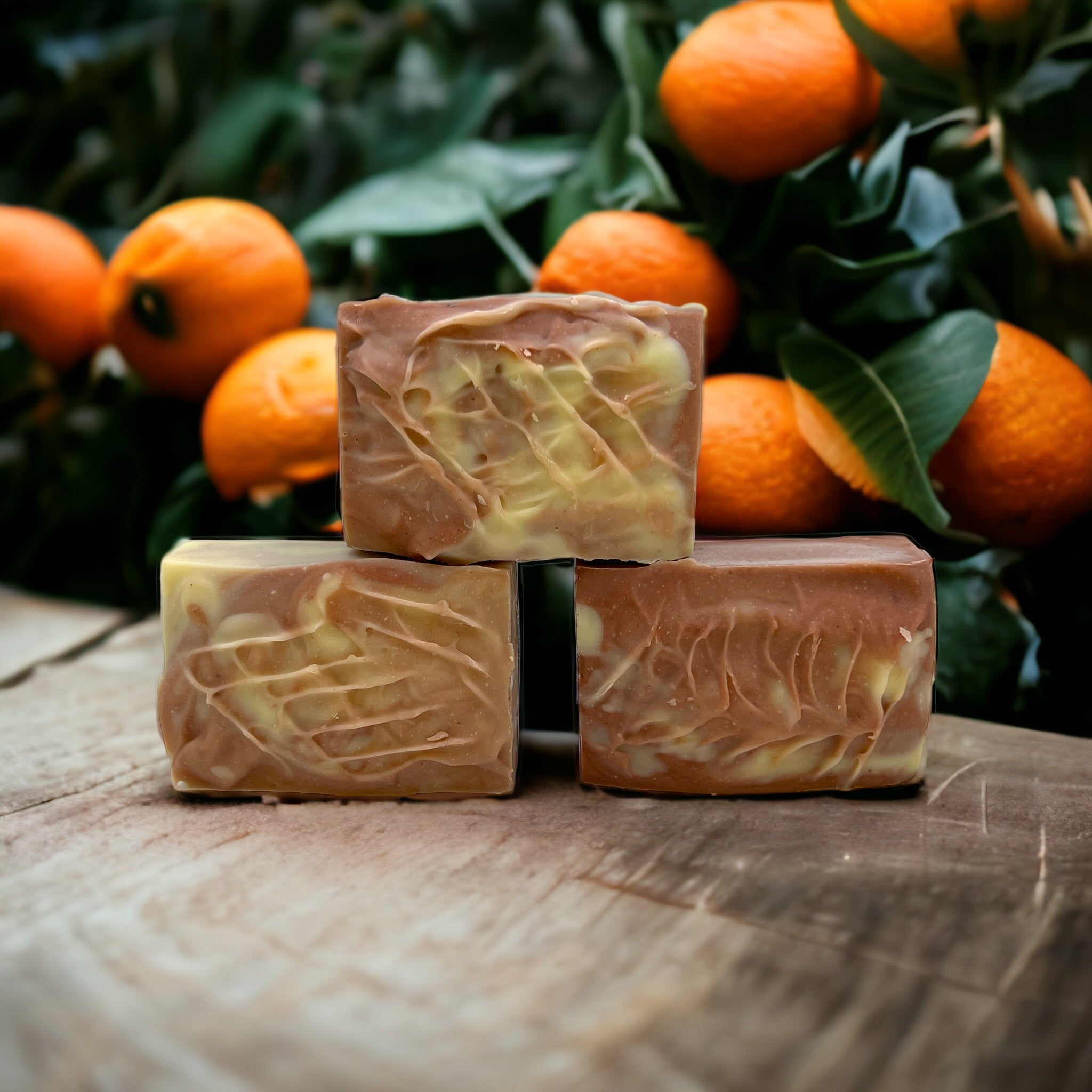 Three handcrafted soap bars stacked with a textured creamy surface.