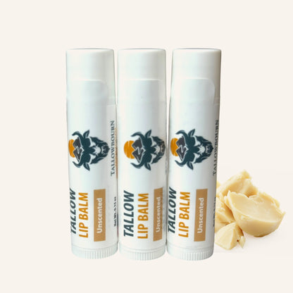 Three tubes of Tallowbourn Tallow Lip Balm on a white background with a piece of tallow.