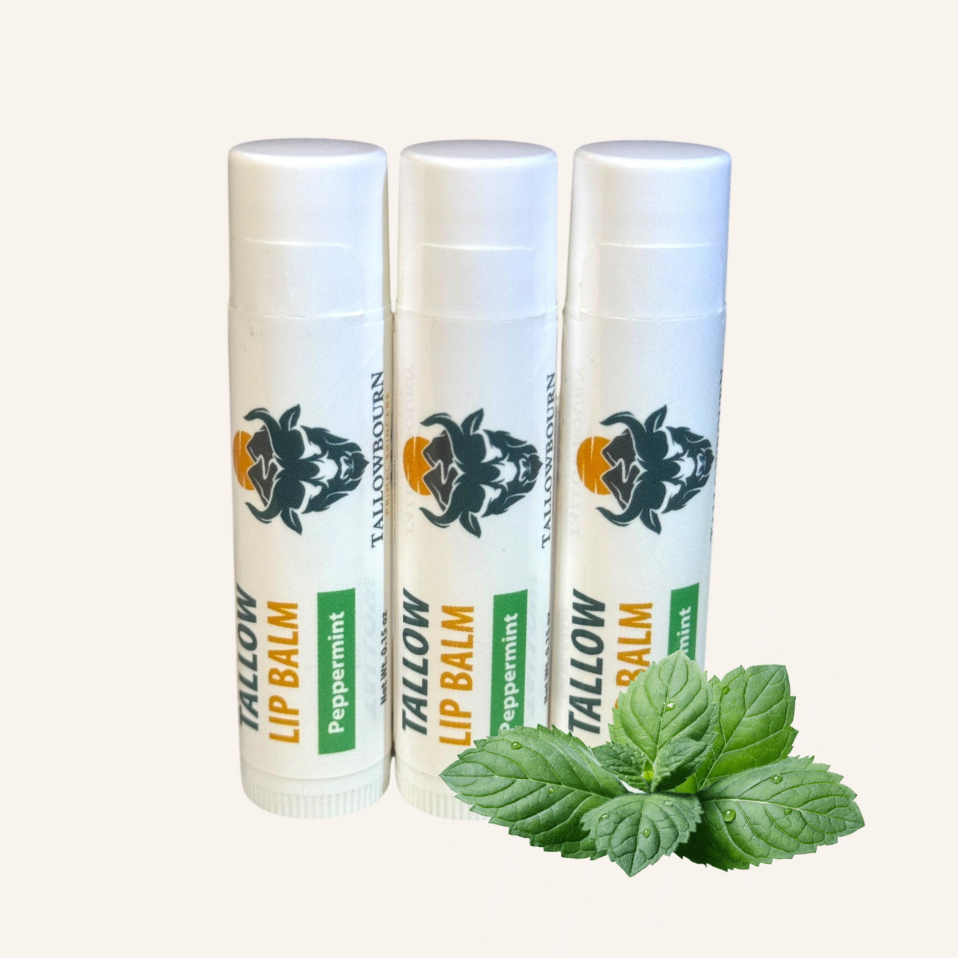 Three peppermint tallowbourn lip balm tubes with a leaf on a white background