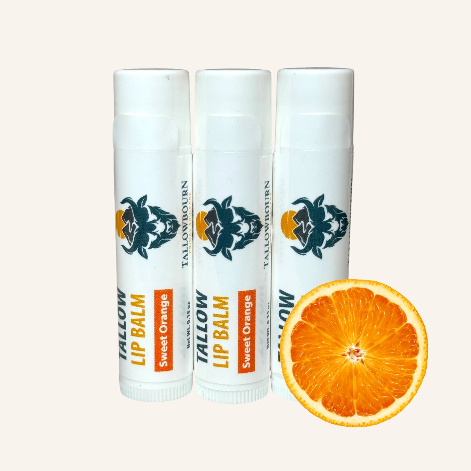 Three Tallowbourn Tallow Balm lip balms with a sweet orange slice on a white background